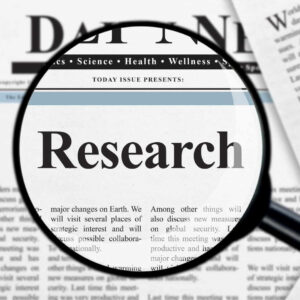 Research written on a e-newspaper showing the importance of research for business growth